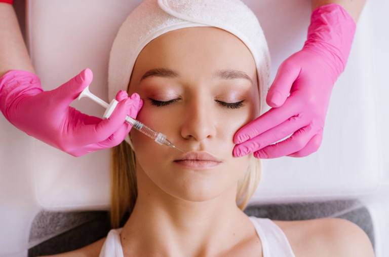 Aesthetic specialist applies dermal fillers to a woman's face at EstrogenicA clinic, enhancing facial volume and achieving a youthful look