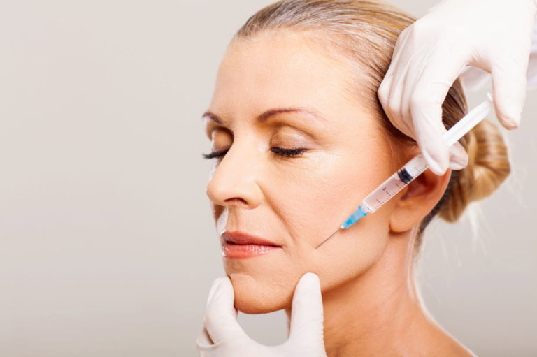 A woman receiving a Botox injection at EstrogenicA clinic, highlighting the precision and care in achieving youthful, smooth skin while exploring the question 'How Long Does Botox Last?